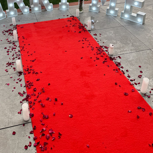 Red carpet hire Melbourne with rose petals and candles for proposal