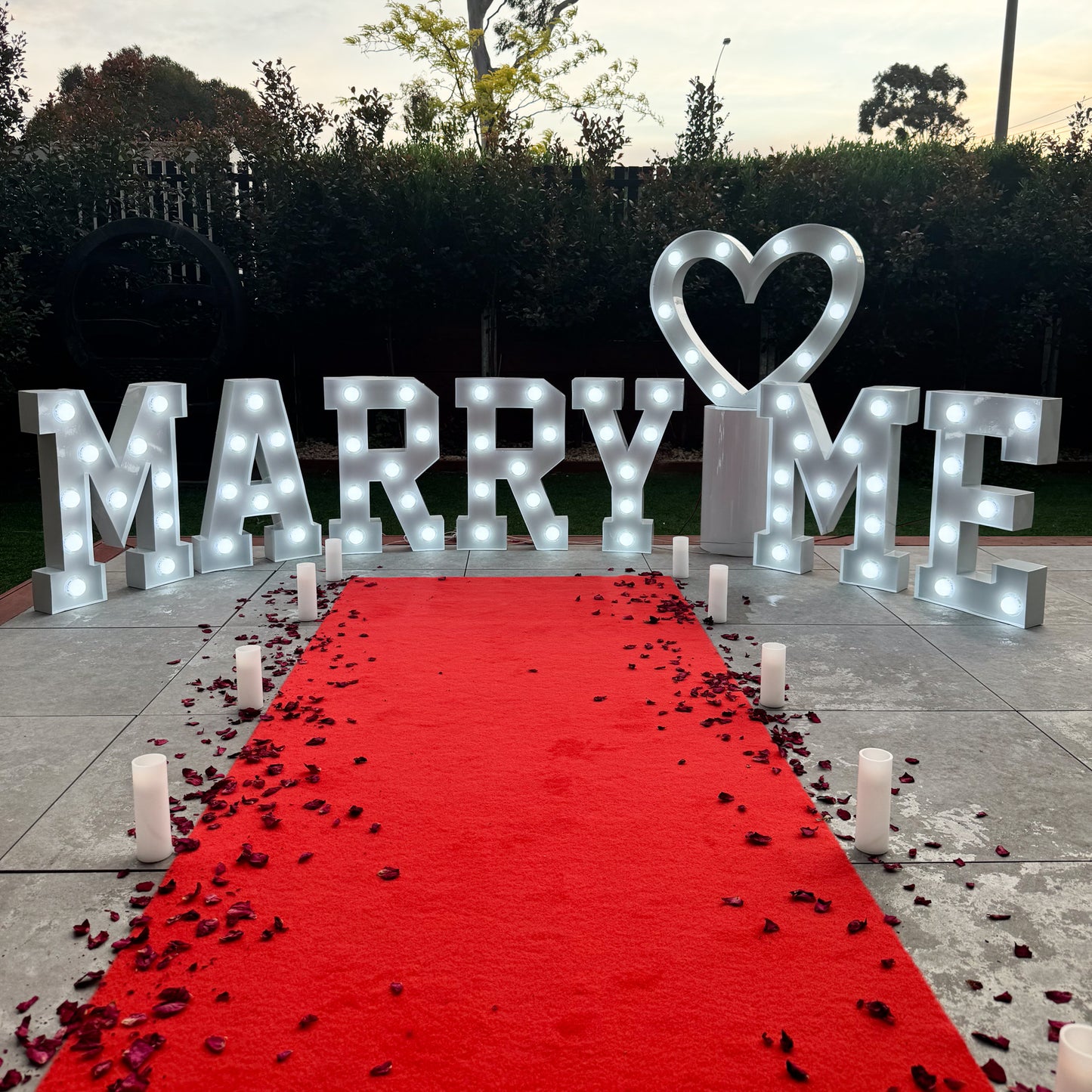 Red carpet hire Melbourne with marry me letters and heart light for proposal