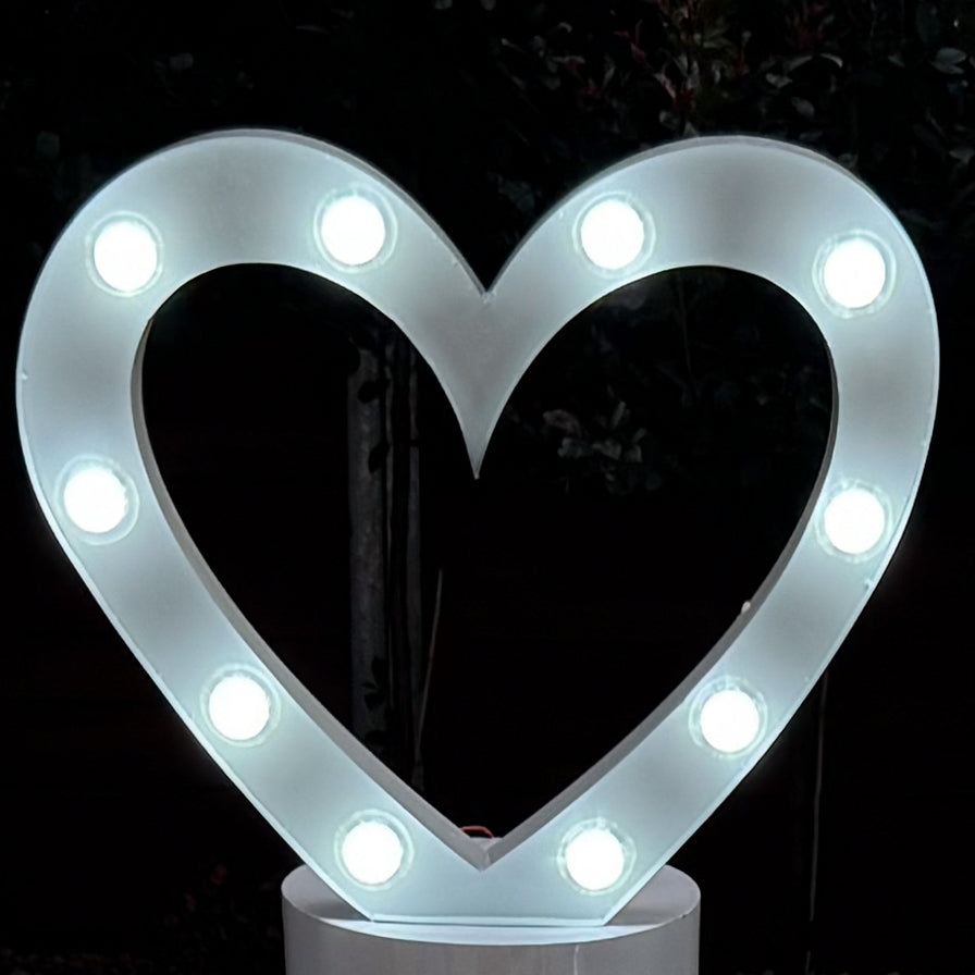 white marquee light in the shape of a love heart