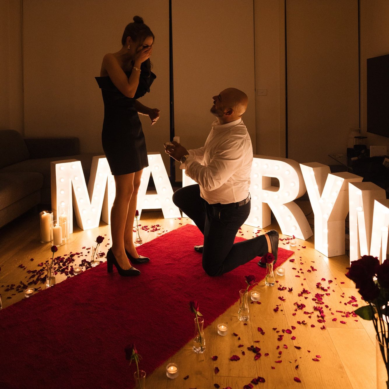 Indoor proposal with red carpet hire Melbourne and marry me marquee letters