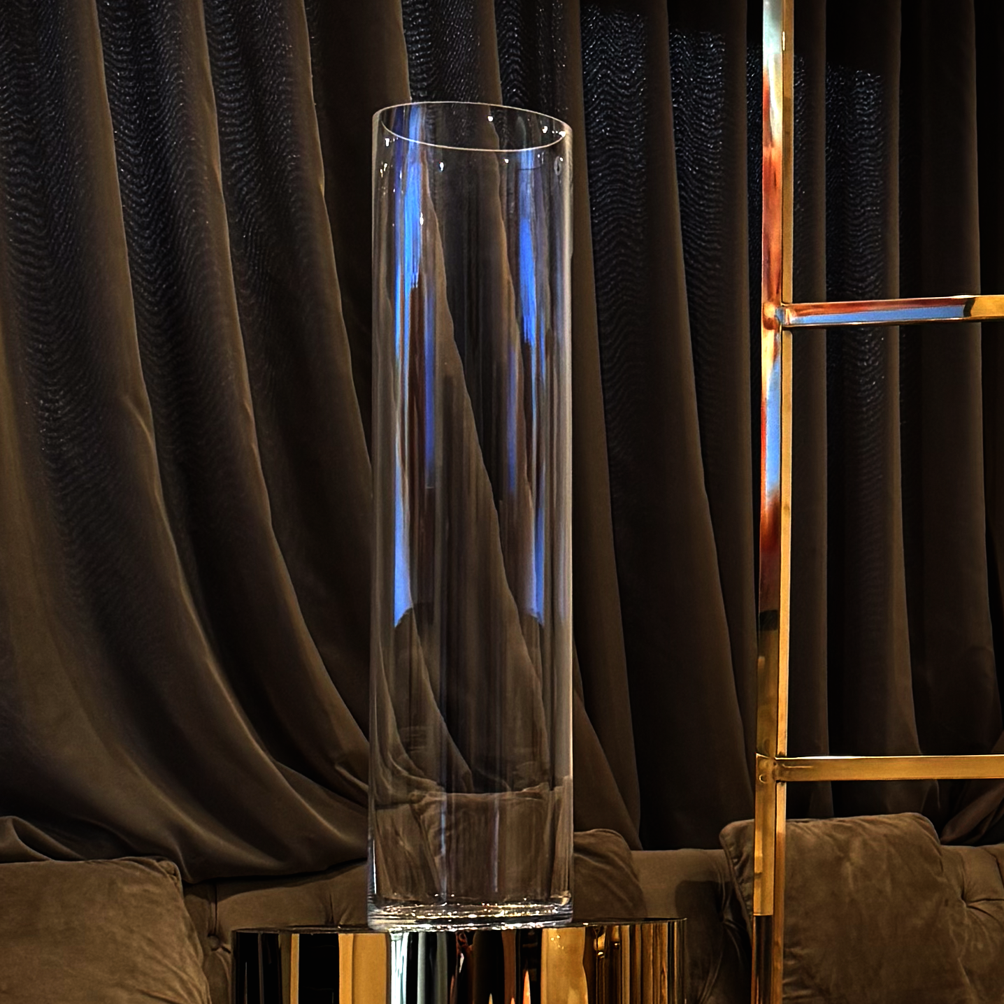 tall glass vase onto of metallic gold plinth