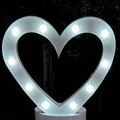 white marquee light in the shape of a love heart