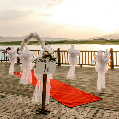 Outdoor proposal setup with red carpet hire Melbourne and floral arch
